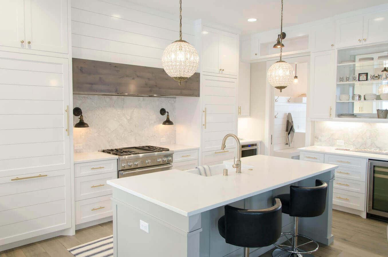 Kitchen with hardwood floor and island with sink and faucet