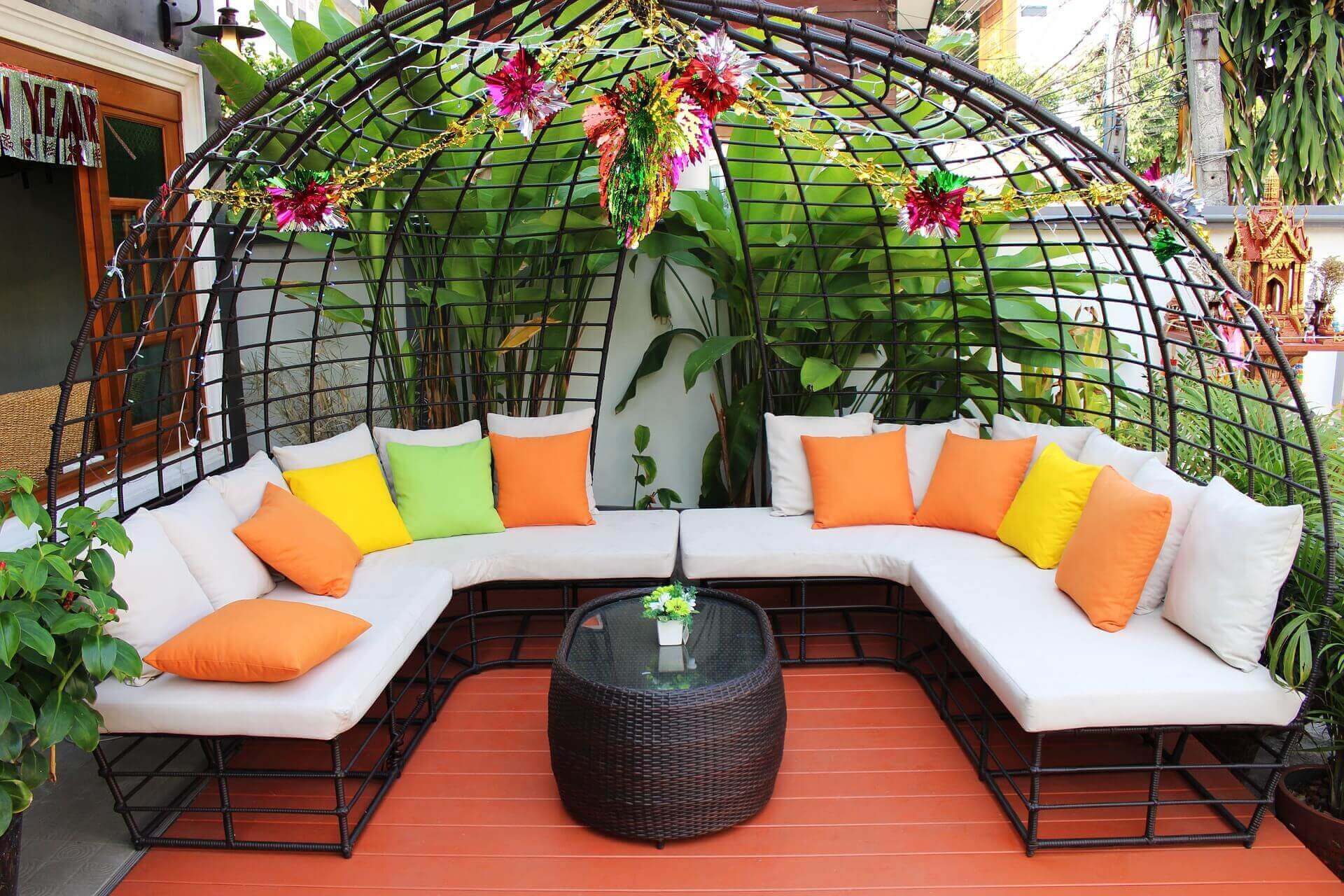 A brightly colored patio with orange flooring, and a large U shaped seating area