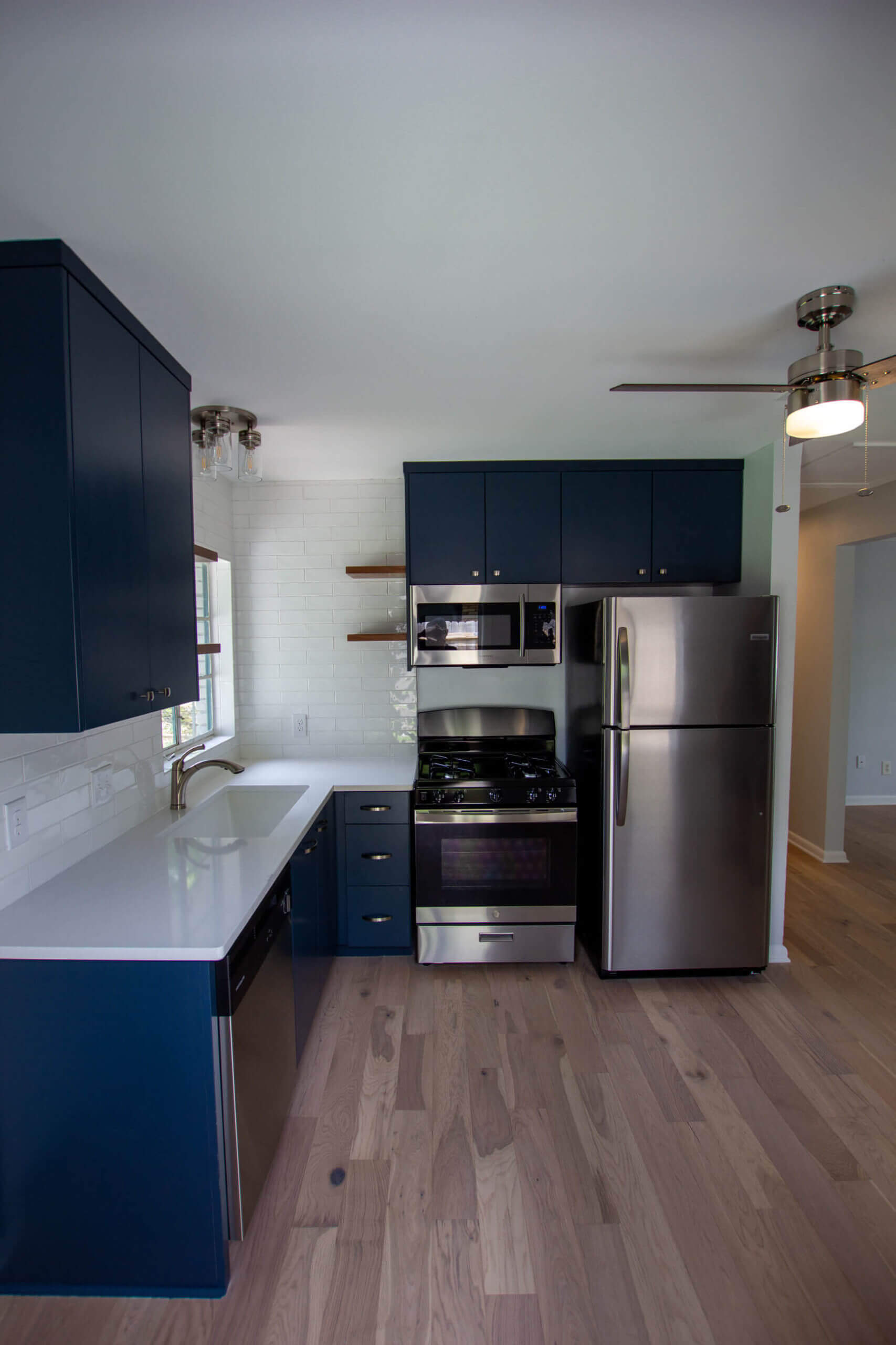 kitchen Remodel with modern blue cabinets and stainless steel appliances. 