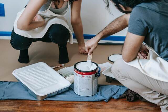 two people paint their room