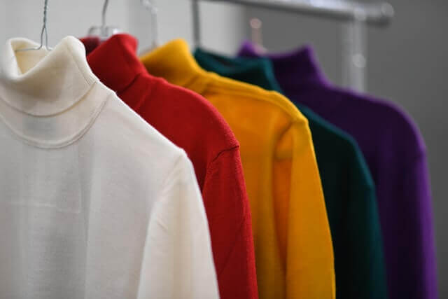 organized sweatshirts in a closet